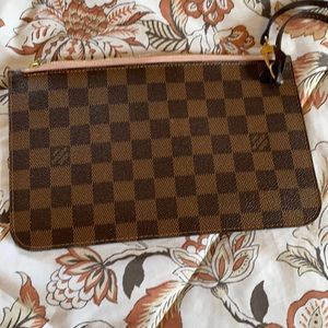 LV wristlet it has a defective on the side it’s auténtic